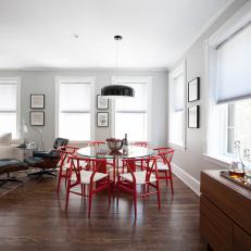 Open, Contemporary Dining Room Features Red Wishbone Chairs
