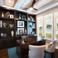 Richly Appointed Home Office Boasts Dark Wood Desk and Wall Unit
