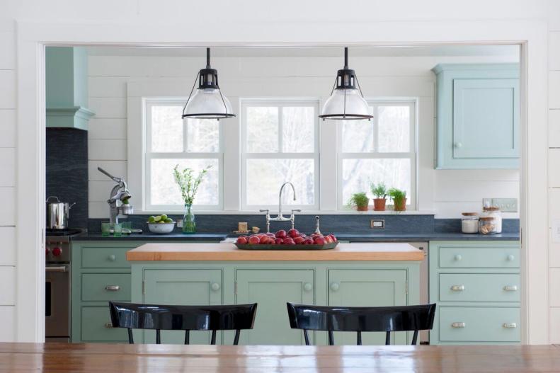 Cottage Kitchen Has Mint-Green Cabinetry and Wood-Topped Island