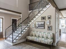 Chic Foyer Features Small Gallery Wall & Floral Settee