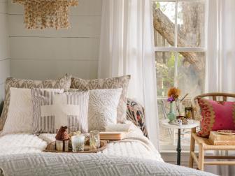 White Bedding, Tan Chandelier & Sheer White Curtains in White Bedroom