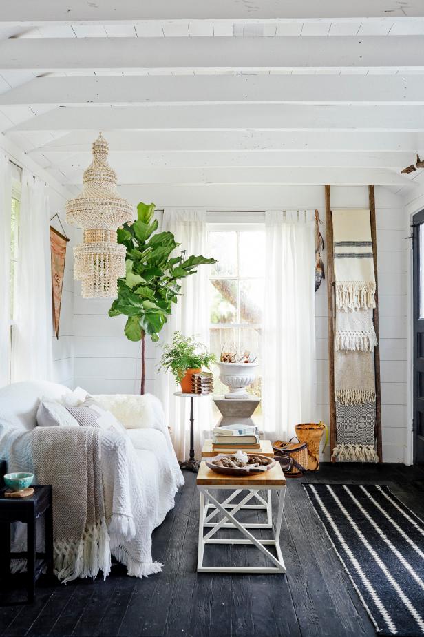 White Living Room With White Ceiling Beams and Shell Chandelier