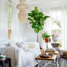 Bright Living Room With Seashell Chandelier, Twin End Tables and White Decor