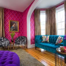Vibrant Sitting Room With Hot Pink Walls and Bold, Tufted Furniture  