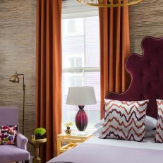 Eclectic Bedroom With Burgundy Headboard, Burnt Orange Curtains and Lavender Accents