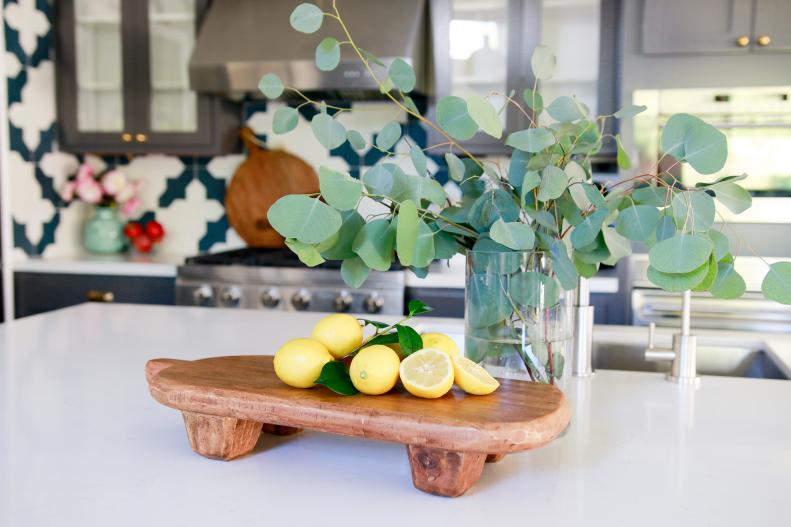 Wood Board With Lemons & Vase of Greenery on Kitchen Island