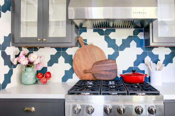 Blue & White Tile Backsplash With Gray Cabinets & Stainless Cooktop