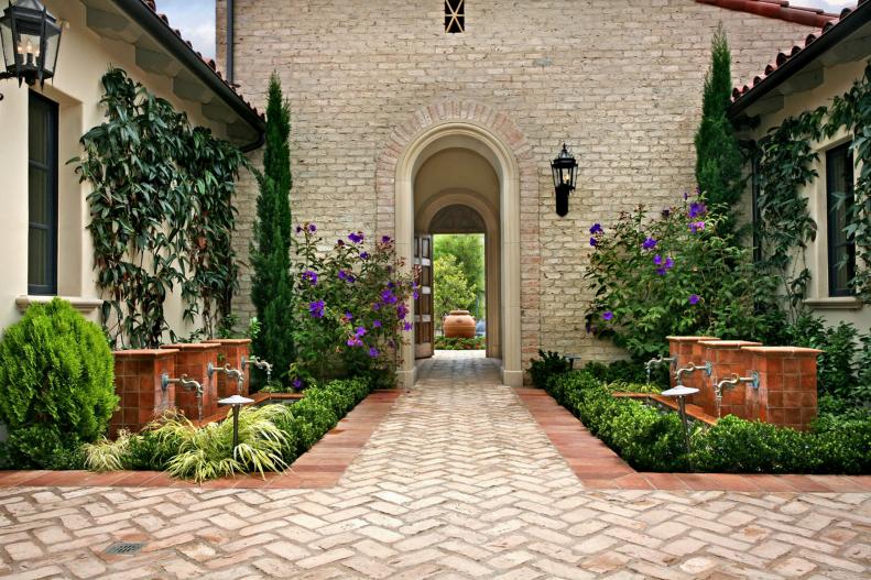 Mediterranean Courtyard With Fountain Features & Colorful Landscaping