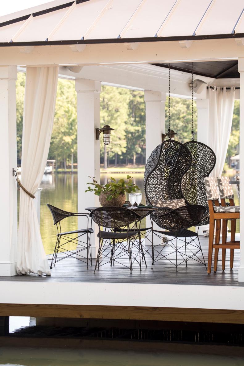 Contemporary Floating Deck on Lake With Black Furniture & White Drapes