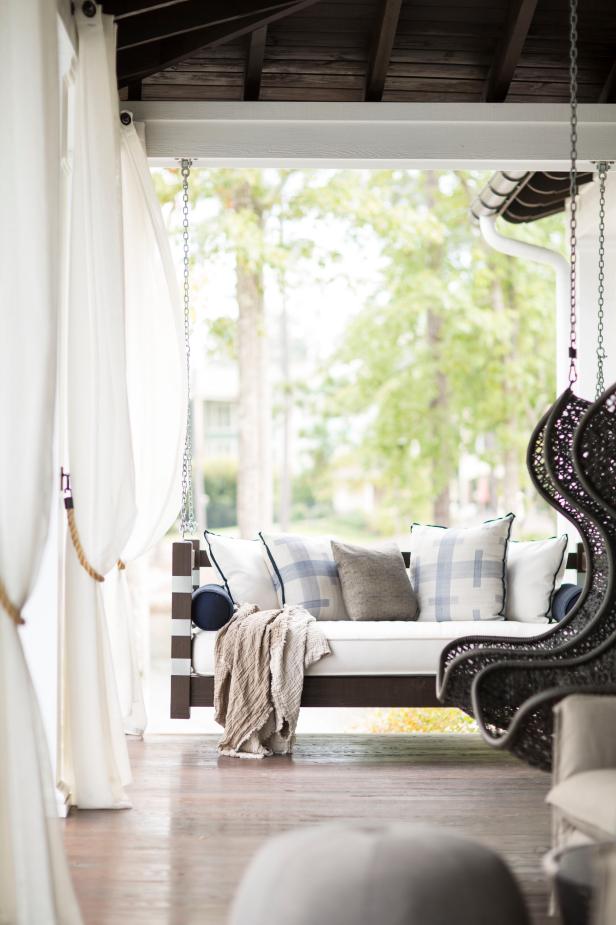 Contemporary Porch With White Drapes & Cushioned Swing