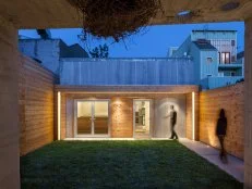 Modern Exterior in Evening With Corrugated Steel & Cedar Siding