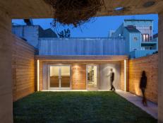 Modern Exterior in Evening With Corrugated Steel & Cedar Siding