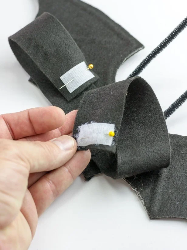 Temporarily place the wings on your pet's back, wrap the strap around their chest and note how much hook-and-loop tape you'll need for the two ends to attach securely. Add hook-and-loop tape, stitching it in place.