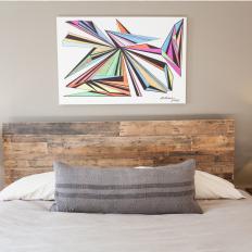 Multicolored Art Above Rustic Wood Bed