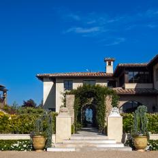 Spanish Villa-style Home with Pergola Leading to the Front Door