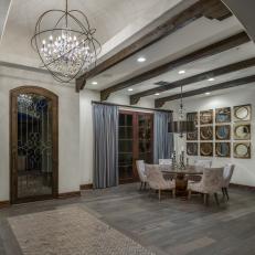 Dining Room With Gray Hardwood Flooring & Exposed Beams