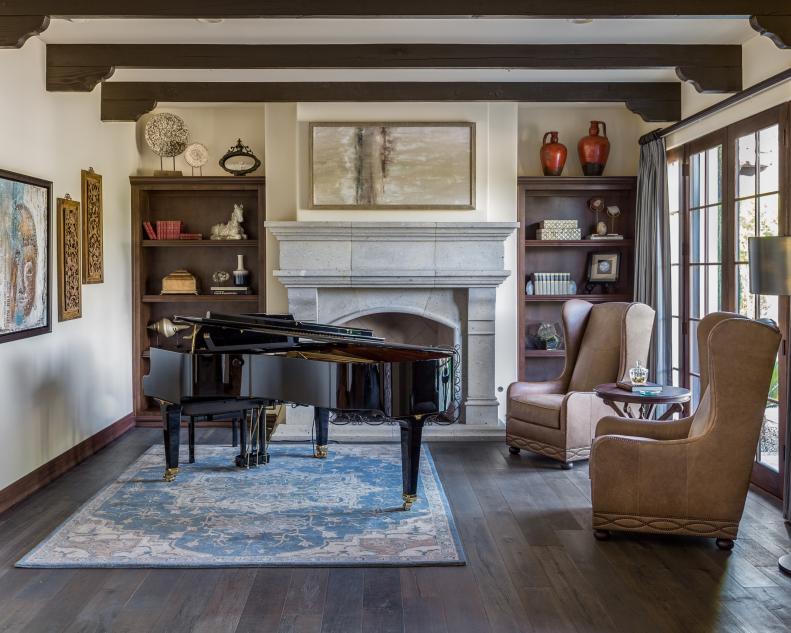 Transitional Living Area With Wood Beams, Stone Fireplace & Piano