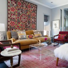 Colorful Eclectic Living Room With Floral Wall Tapestry, Mustard Yellow Sofa and Faded Red Rug 