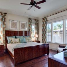 Stylish Wood Transitional Bedroom With Patterned Wood Bed Frame and Blue, Green and Brown Decorative Accents