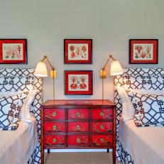 Guest Room Features Graphic, Upholstered Beds & Bold Red Accents