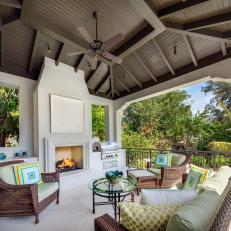 Outdoor Room Features Cushioned, Wicker Furniture & Fireplace