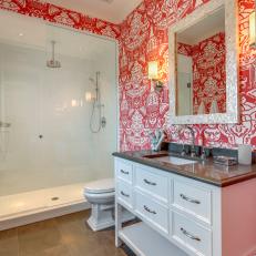 Bold Orange Tropical Wallpaper in Bathroom With Pearl Framed Mirror, Sliding Glass Door Shower and Traditional White Vanity