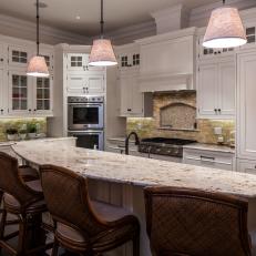 Eat-In Kitchen Boasts White Cabinetry & Raised Breakfast Bar