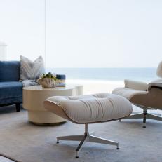 Contemporary Sitting Room with Blue Sofa, Neutral Chair and Ottoman, Circular Coffee Table 