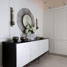 Living Space with Wallpapered Ceiling, White Paneled Walls and Wood-and-metal Sideboard Hutch