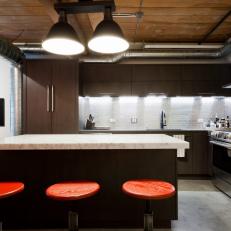 Industrial Kitchen With Wood Cabinets & Red Barstools
