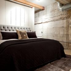Industrial-Style Bedroom With Gray Headboard & Brown Bedding