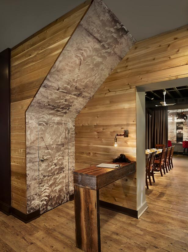 Hostess Station With Recycled Wood Walls and Nature Wall Mural