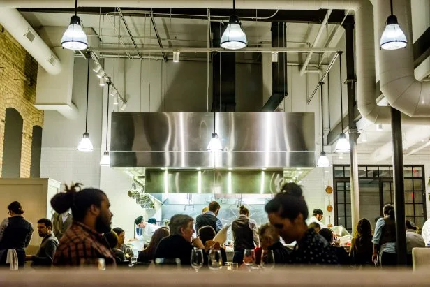 Restaurant With High Ceilings and Exposed Ductwork