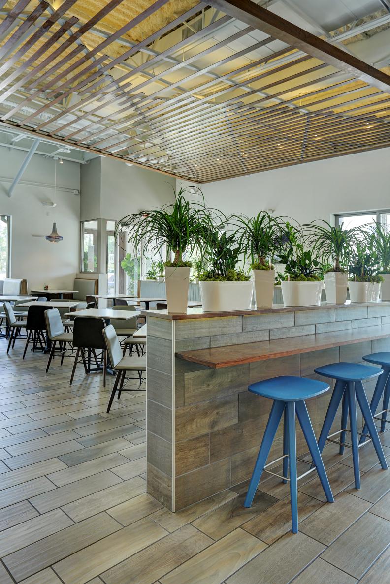 Contemporary Restaurant Waiting/Dining Area With Blue Barstools