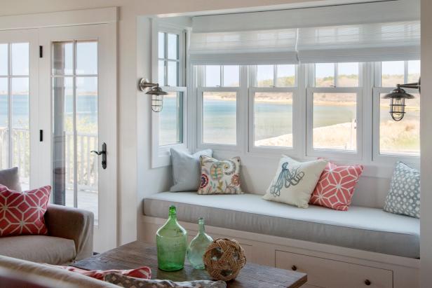 White Window Seat With Light Blue Cushion in Coastal Living Room