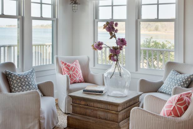 Coastal Sitting Room With Four Neutral Armchairs and Wood Table