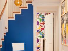 Foyer With Royal Blue Accent Wall and Classic Wood Staircase