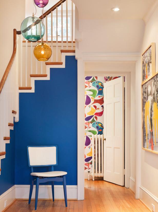 Foyer With Royal Blue Accent Wall and Classic Wood Staircase