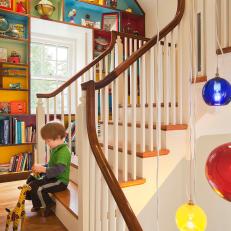 Colorful Shelving Pops Against Classic Wood Staircase