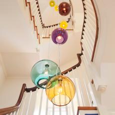 Colorful Chandelier Illuminates Traditional Stairway