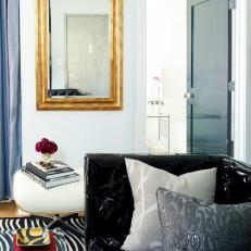 Feminine Apartment Living Room Features Gold Mirror & Animal Prints