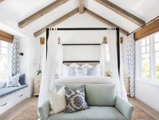 Coastal White Bedroom With Exposed Ceiling Beams and Canopy Bed