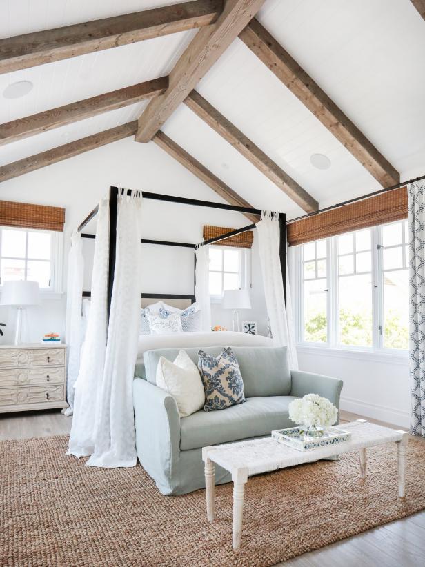 Coastal White Master Bedroom With Blue-Green Loveseat and Canopy Bed
