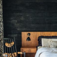 Low-Profile Midcentury Bed Against Charred Wood Wall