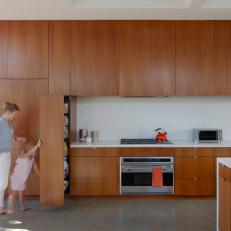 Modern Kitchen With Warm Wood Cabinets and Concrete Floors