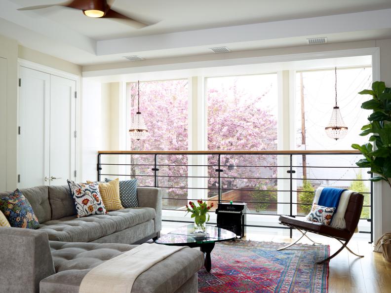 Living Space With Gray Sectional and Contemporary Metal Railing