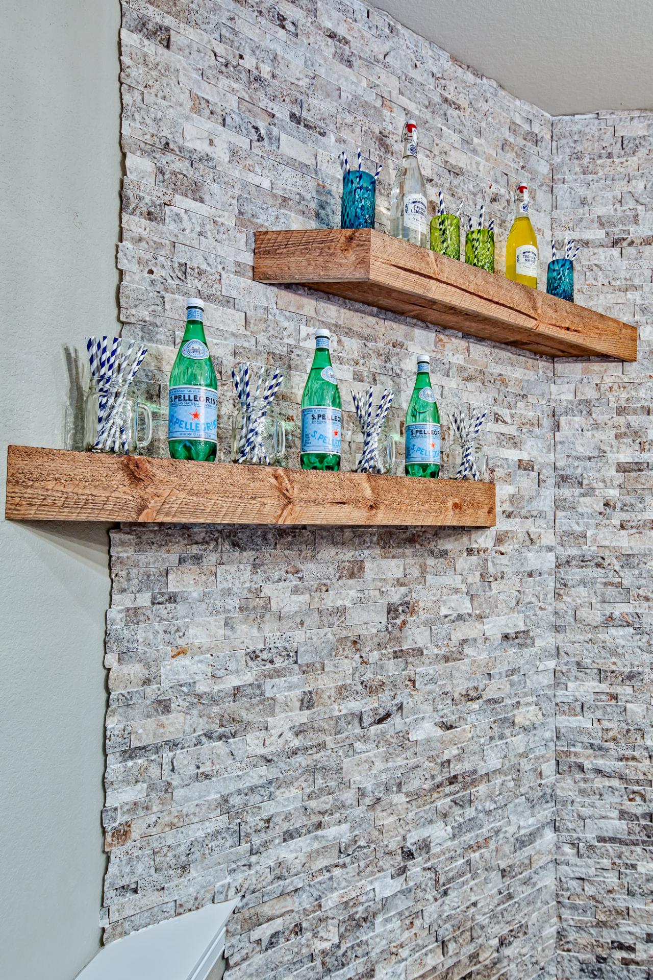Rustic Wood Floating Shelves and Stone Wall | HGTV