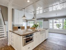 Airy White Kitchen With Rustic Hardwood Floors
