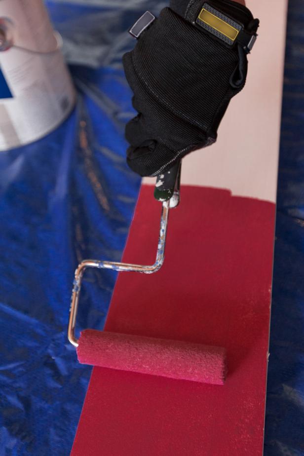 Once all your cuts are complete, set up a painting zone with all your supplies and a drop cloth. Paint the planks using a small paint roller and interior latex paint, then allow ample time to dry