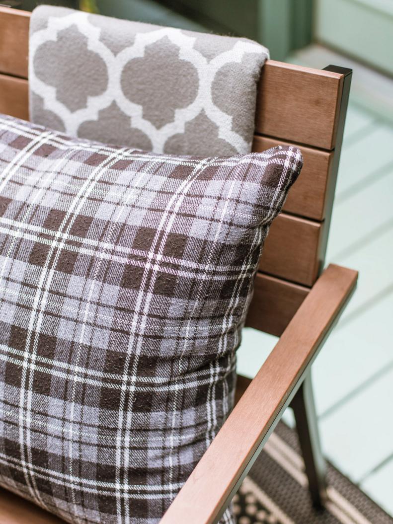 Plaid Throw Pillow and Trellis-Patterned Throw on Dining Chair